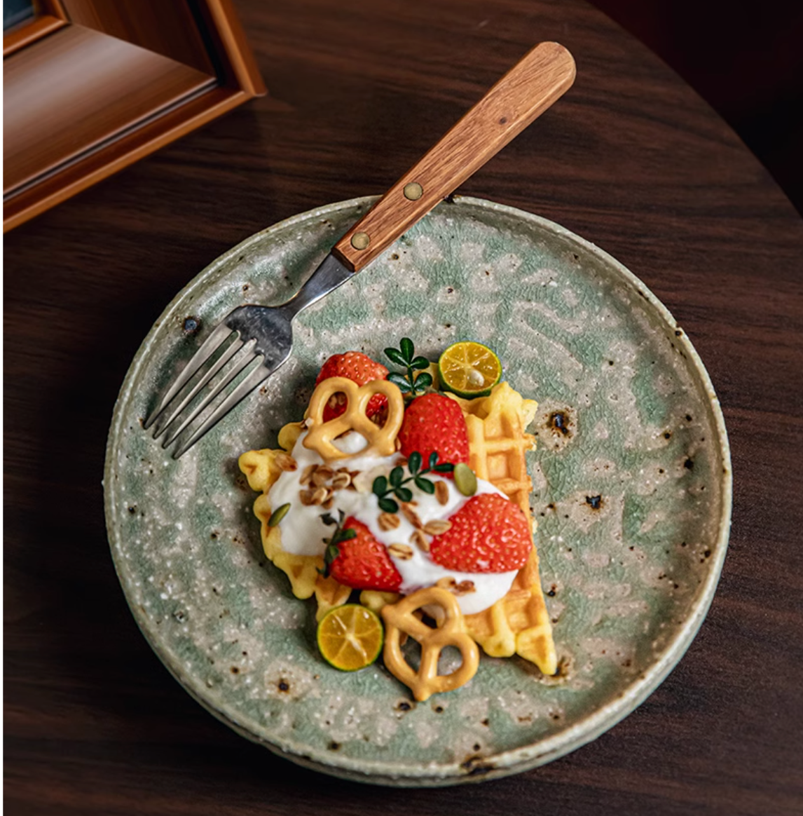 Artisan Green Dinnerware serving a waffle with strawberries, yogurt, and pretzels.